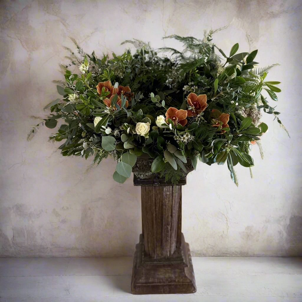 Garden urn spray with orchids and white roses