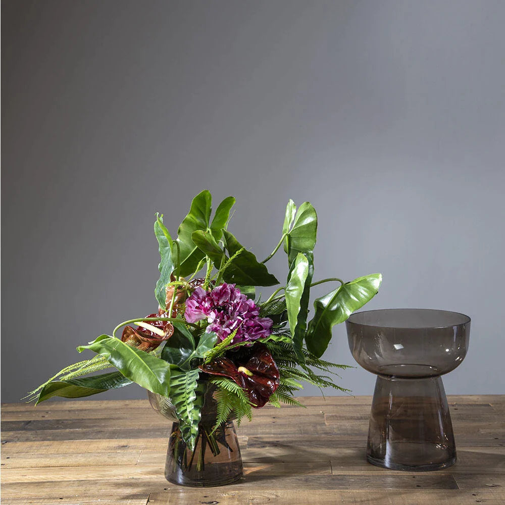 Fresh flower arrangment displayed in the Noemi Vase on a wood tabletop.