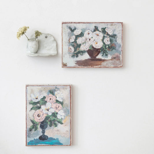 Both styles of the canvas wall decor with flowers in base mounted on wall with a stoneware shelf.